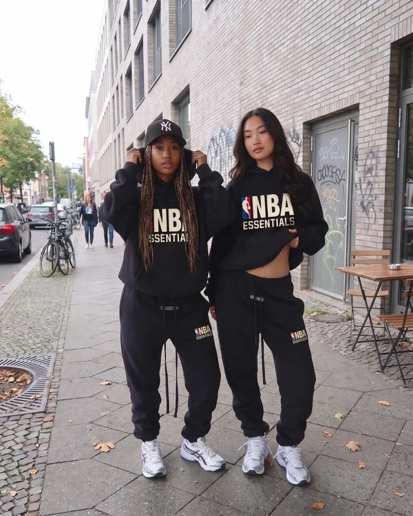Zwei Models in schwarzen NBA Essentials Sets auf der Strasse